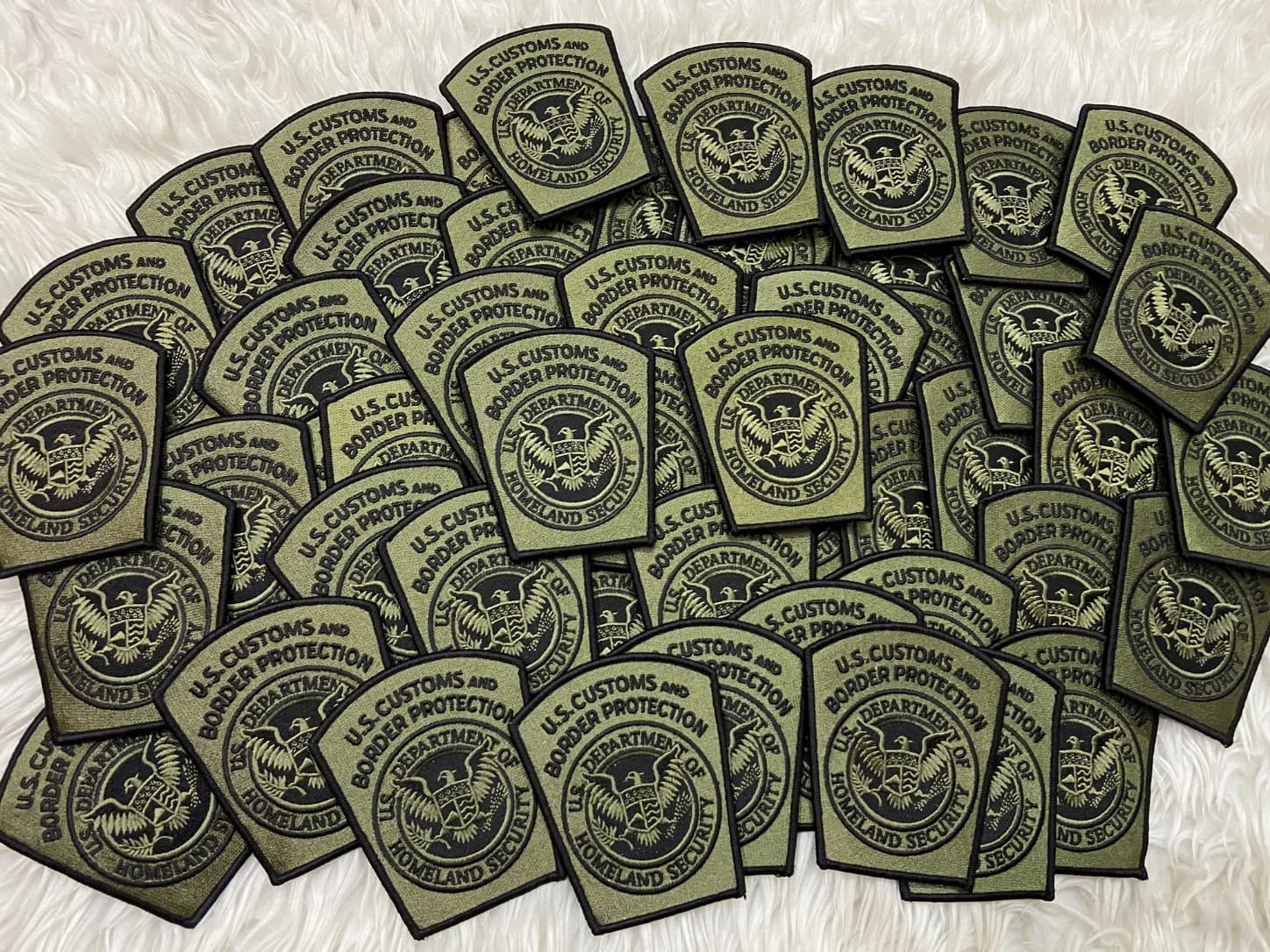 Olive and black patches with U.S. Customs and Border Protection lettering