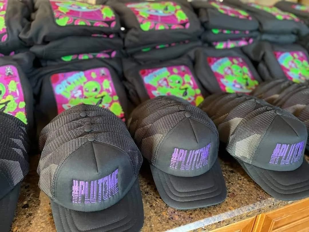 Black mesh caps with purple embroidered lettering