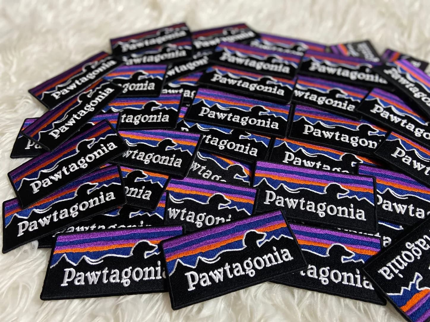 Rectangular Pawtagonia patches with purple and orange stripes